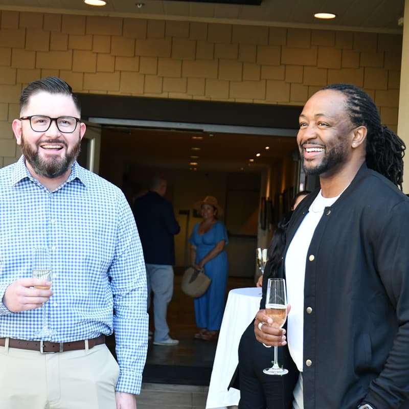 Two attendees talking at the evening reception