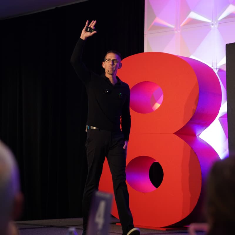 Keynote speaker with a raised fist on stage